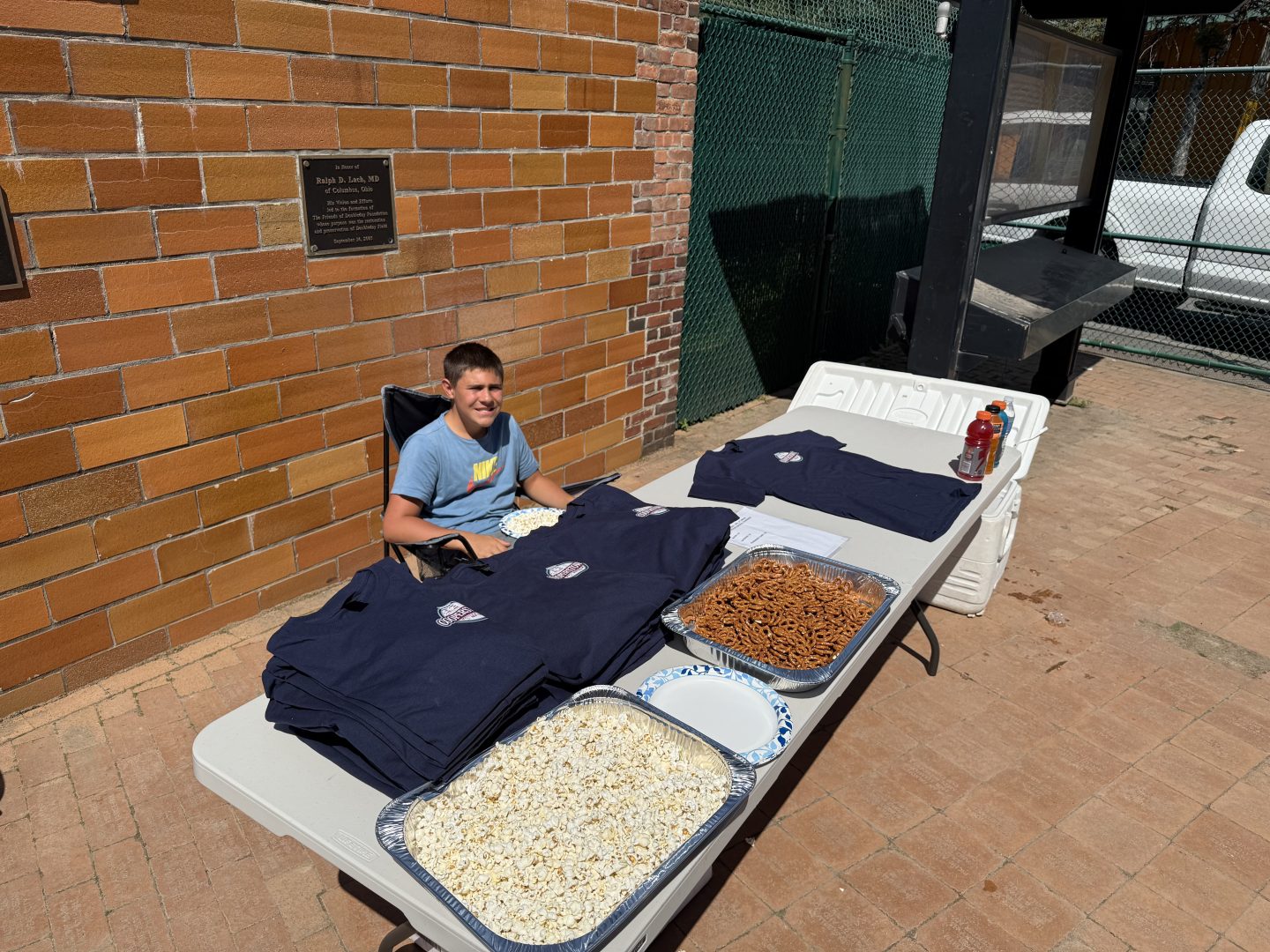 Baseball event table with shirts and snacks at League of Our Own.
